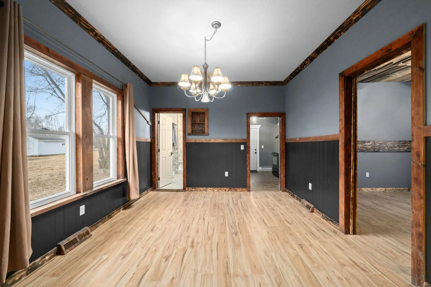 Room with new wood flooring and stained trim