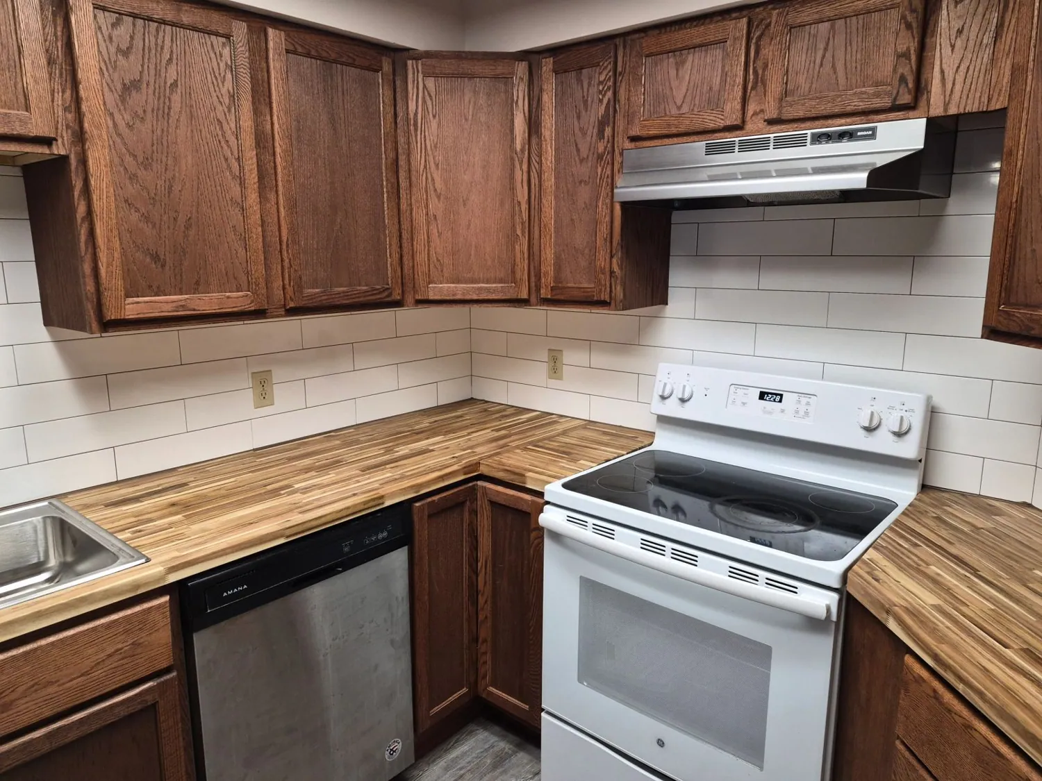 Kitchen corner with butcher-block counters and subway tile