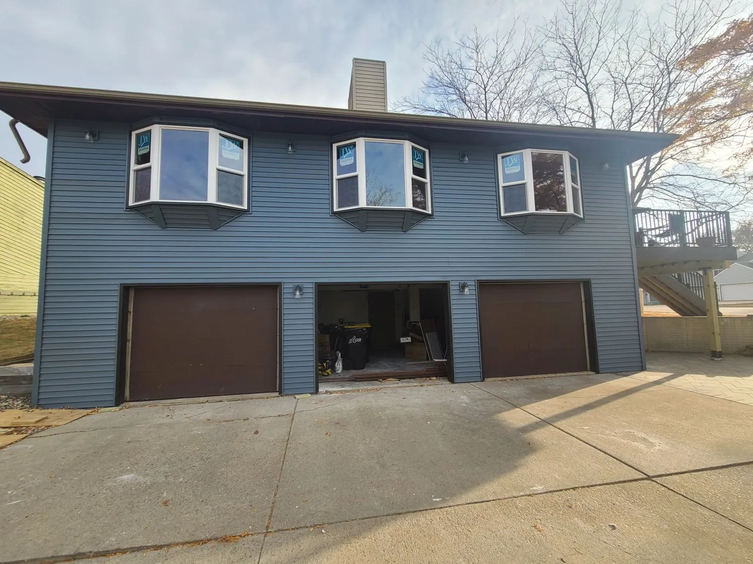 Two-story home with new blue siding
